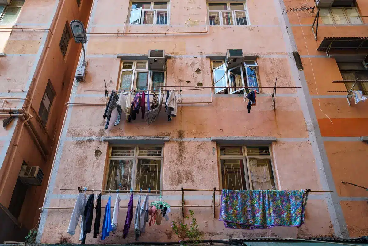 Petit séchoir à pinces en bleu pastel suspendu avec du linge léger dans un petit espace