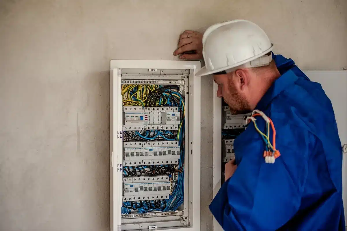 Technicien travaillant sur l'installation d'un moteur électrique dans un autocar en atelier