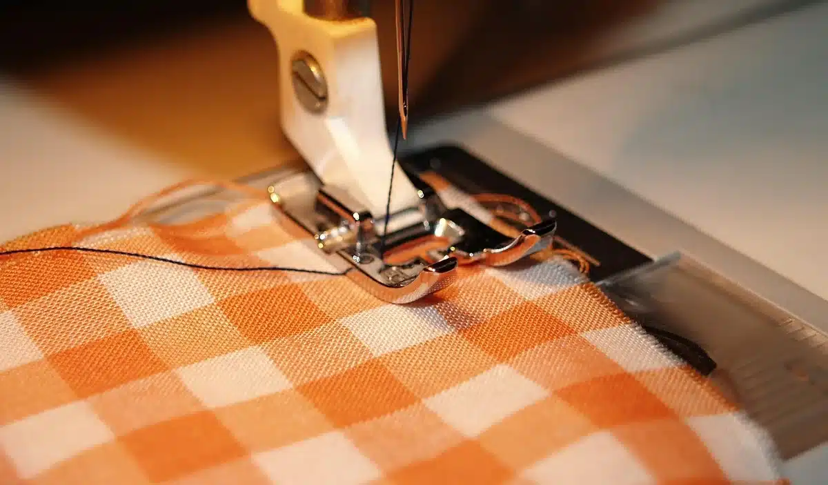 Nappe pliée près d'une machine à laver prête pour un cycle délicat